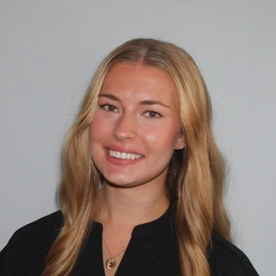 Chiropractic Allen TX Callie Schattle Callie Schattle smiling in a black shirt.