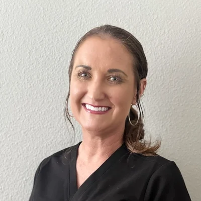 Chiropractic Allen TX Jayme Pyle Jayme Pyle smiling in a black shirt.